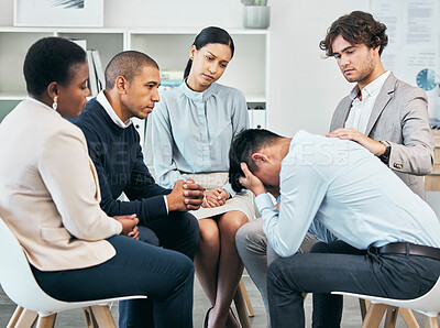 Buy stock photo Depression, support and unity by colleagues comforting male after getting bad news at work. Community care from workers sitting together, supporting their friend after being fired or through grief