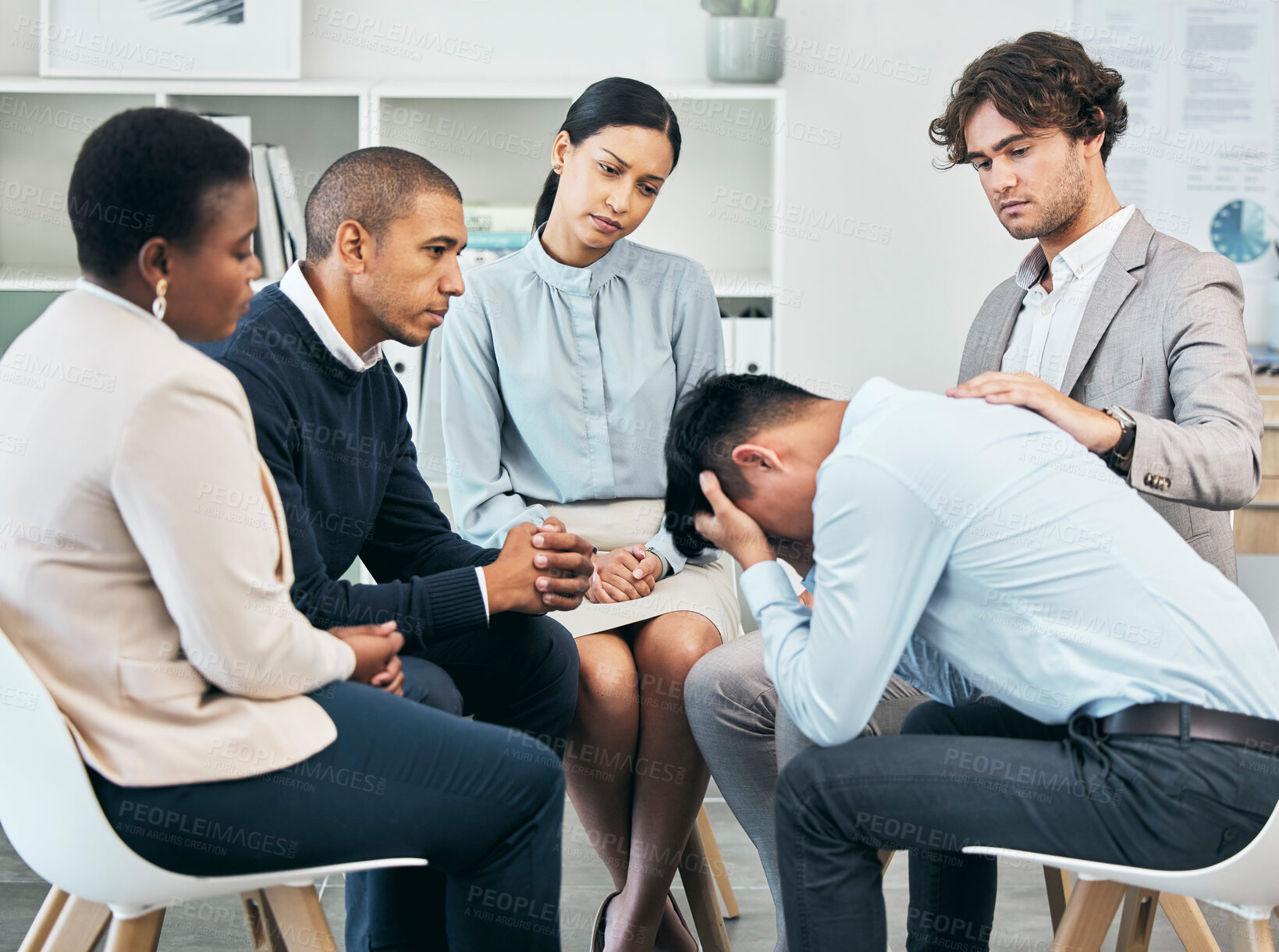 Buy stock photo Depression, support and unity by colleagues comforting male after getting bad news at work. Community care from workers sitting together, supporting their friend after being fired or through grief