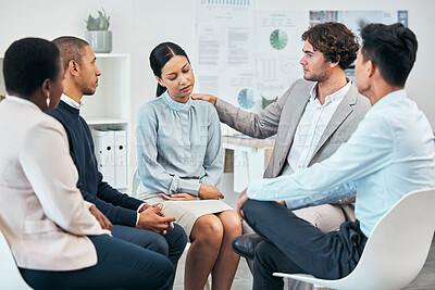 Buy stock photo Diverse colleagues support and comfort unhappy, sad coworker at team meeting or gathering. Compassionate, caring employees showing empathy to distressed woman in work group therapy session.