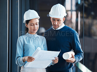 Buy stock photo Architecture, civil and architect engineers busy with a floor plan or blueprint strategy on paper inside a office building. Designers working, planning and analyzing a construction project together