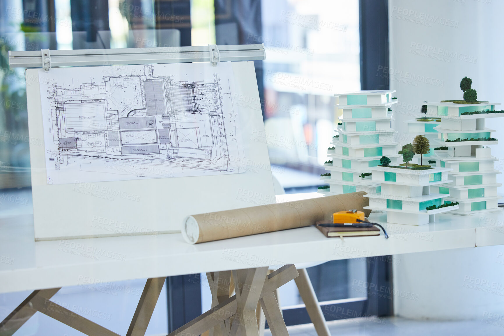 Buy stock photo Architecture, design and blueprints on an office desk with plans and a building model for the construction industry. Architect office, planning and equipment in a modern and creative workplace