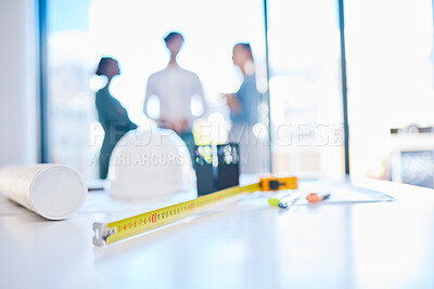 Buy stock photo Creative engineering designer discuss building plans in a corporate business. Measure tape on a table or desk in an architecture company office with engineer employee consulting in the background