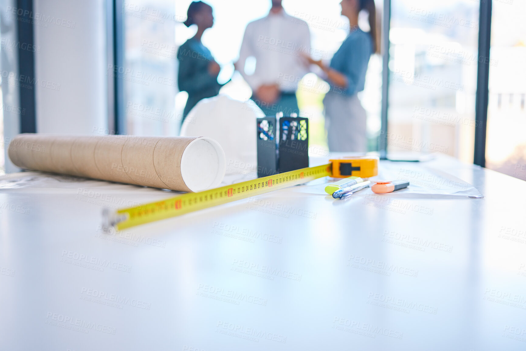 Buy stock photo Architecture, construction and building with plans, blueprints and tape measure on a desk in an architect office. Closeup of engineer or contractor equipment on a table ready for planning and design