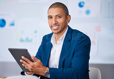 Buy stock photo Successful financial businessman smiling while browsing on a digital tablet in the office. Portrait of a male professional accountant feeling positive after completing a deal or finishing a work task
