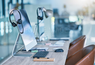 Buy stock photo Headphone or headset in an empty call center office with computer monitor display for online customer service or support. Helpdesk hotline assistance gadgets and crm equipment in workplace or station