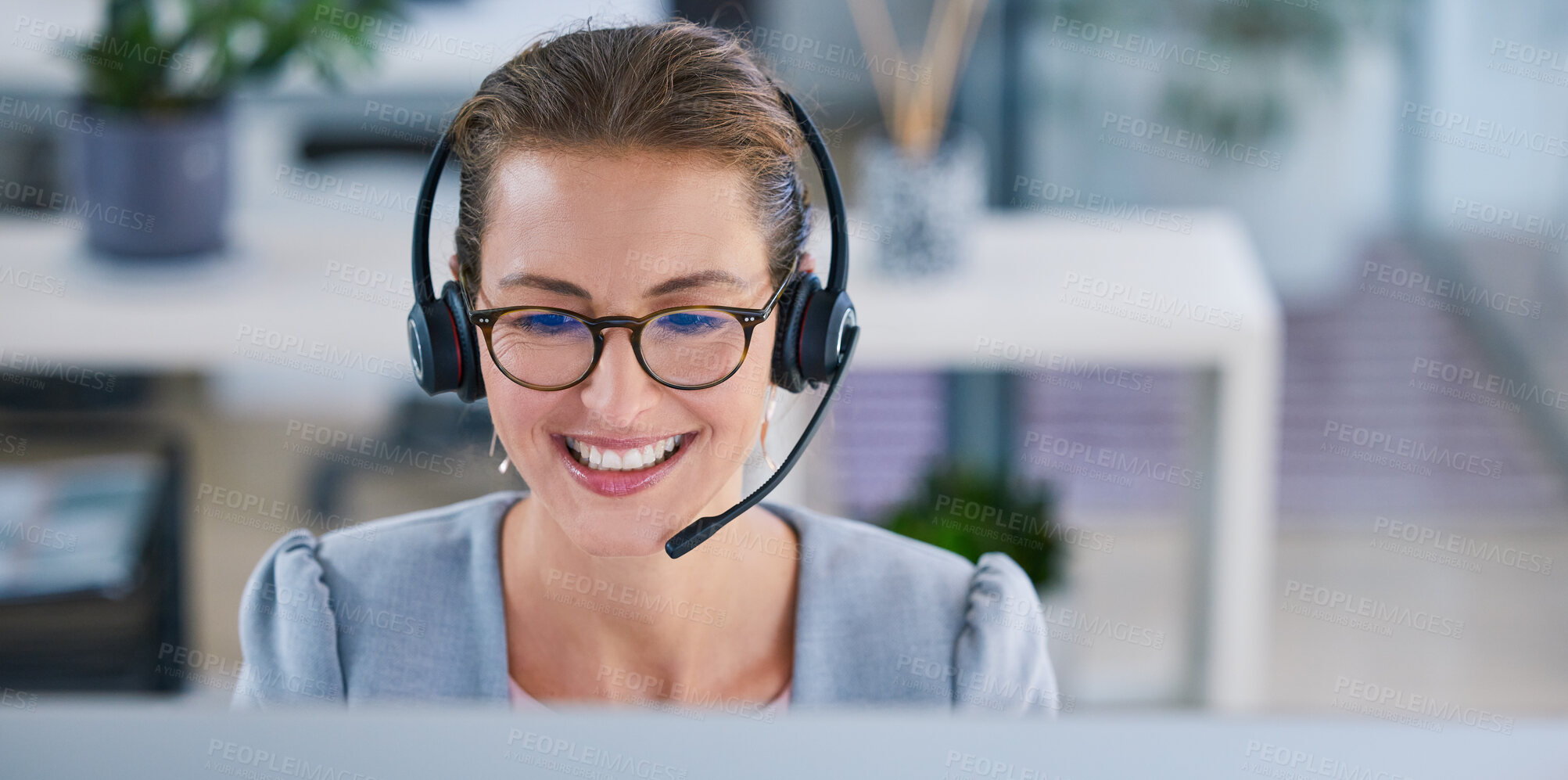 Buy stock photo Happy, smiling and friendly call center agent or telemarketing operator wearing headset while working in an office. Smile of a sales consultant operating helpdesk for customer and service support
