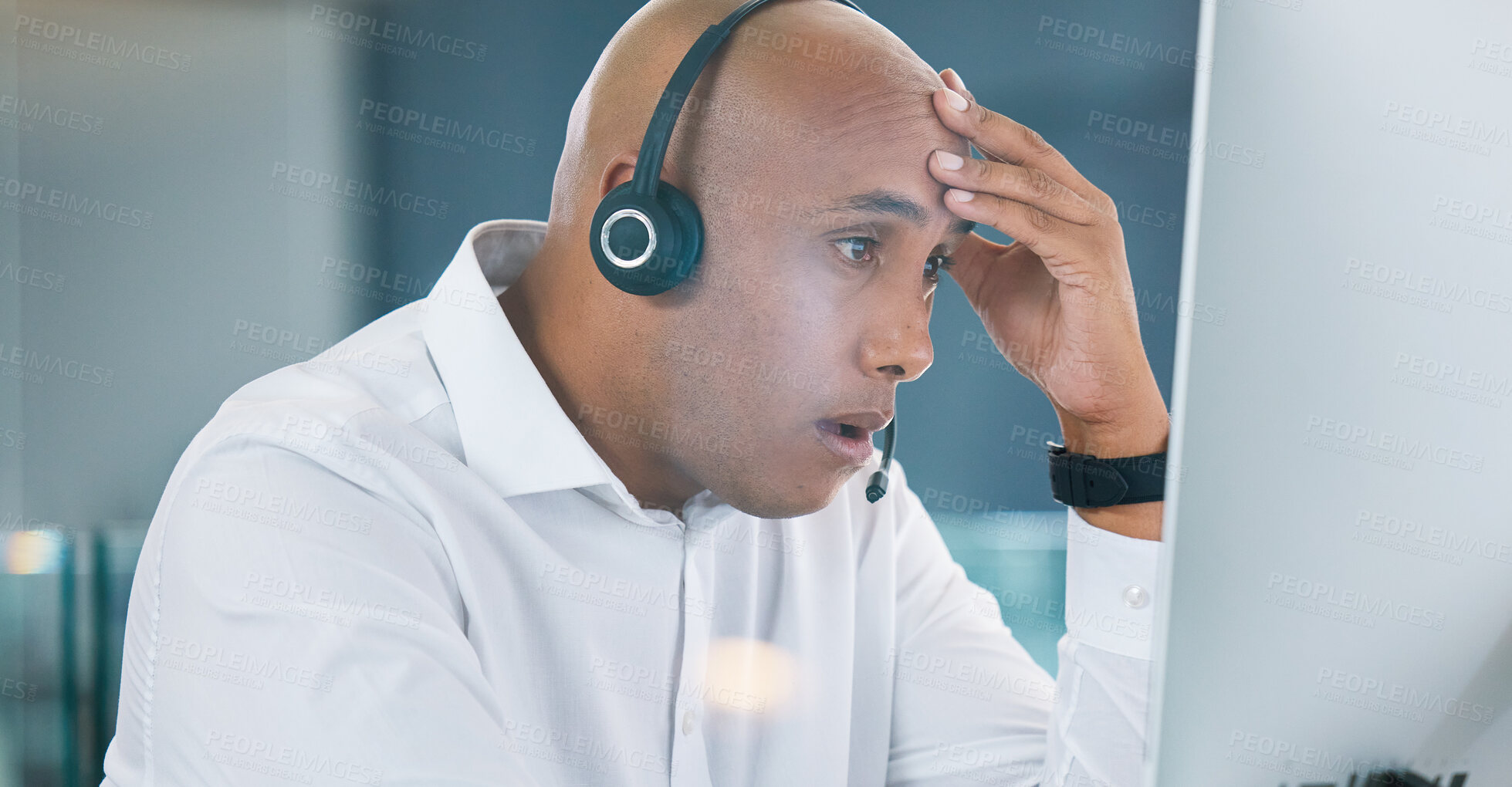 Buy stock photo Shocked, stressed and annoyed call center agent having a bad day at work feeling unhappy and having problems. Tired, bored and frustrated male customer service consultant looking at his computer