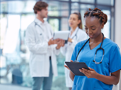 Buy stock photo Female nurse or doctor browsing on a tablet for patient diagnosis or treatment on a medical or mobile healthcare app in a hospital. Professional gp or surgeon wearing scrubs while working in a clinic