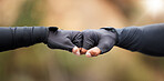 Fist bump, motivation and workout success of fitness friends after sports training in nature. Closeup of a hand gesture doing an exercise goal showing community, support and teamwork collaboration