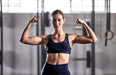 Buy stock photo Gym, fitness and woman flexing muscles with energy to show off her biceps and strong abs in a sports studio. Training, exercise and workout motivation of a healthy, body and muscular in a portrait
