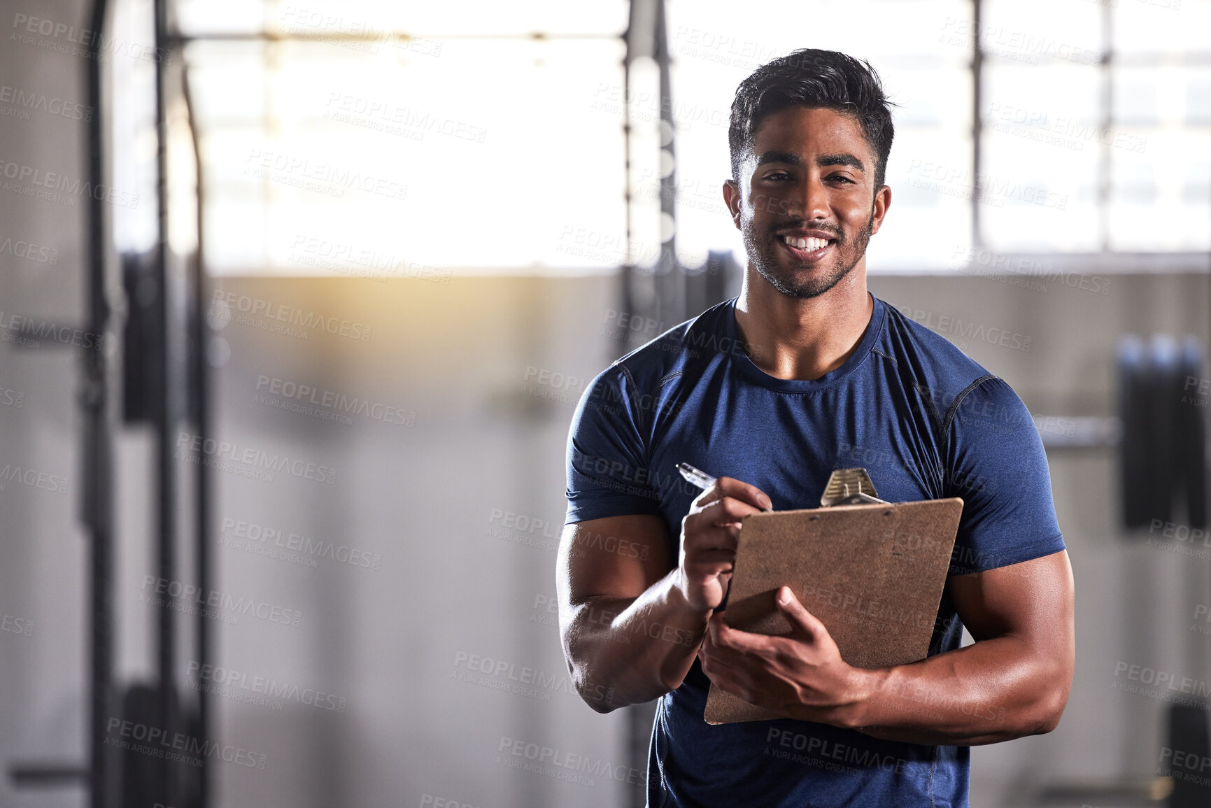 Buy stock photo Gym, workout and personal trainer with clipboard consulting at a training sports in gym. Portrait of muscular, active and smiling fitness coach writing on health, wellness and exercise with flare