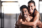 Fitness couple, gym friends and team hugging, holding and celebrating successful workout, training and exercise together. Portrait of smiling, happy and healthy man and woman after wellness teamwork
