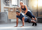 Strength, strong and wellness couple exercising, training or workout exercise inside gym. Sporty professional fitness woman and man doing pushup or working on balance in a physical endurance session