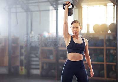 Buy stock photo Strong, powerful woman doing kettlebell weight lift exercise, workout or training in wellness gym. Sports person holding or exercising with fitness equipment for muscle, strength or health portrait