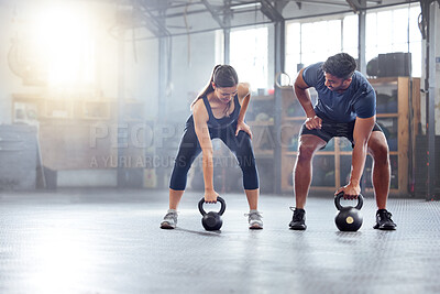 Buy stock photo Fitness couple doing a kettlebell workout, exercise or warmup training in a gym. Fit sports people, woman and man with a strong grip, exercising using equipment to build muscles and forearm strength.