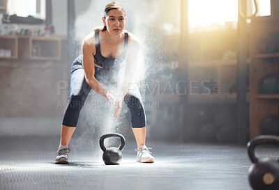 Buy stock photo Fitness kettlebell and gym woman with chalk on hands during weightlifting workout, exercise or training. Athletic, active and strong girl exercising with weight equipment to build muscle strength