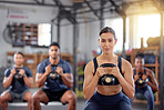 Kettlebell squats, fitness and training group of healthy people living an active health, wellness and body or weight watching lifestyle. A sports team doing a workout or exercise in a gym class