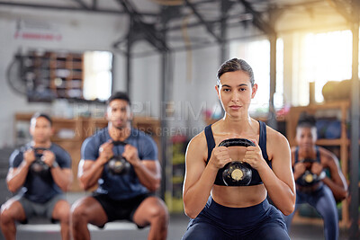 Buy stock photo Kettlebell squats, fitness and training group of healthy people living an active health, wellness and body or weight watching lifestyle. A sports team doing a workout or exercise in a gym class