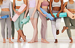 Class of diverse wellness, yoga and female friends standing in health studio or gym relaxed and happy. Woman fitness team in row with exercise mats before workout, meditation and peaceful zen session