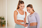 Fit, happy and athletic women laughing at funny social media posts on a phone before exercising together. Young athletes or workout friends browsing online or the internet and having fun