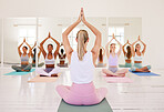Zen yoga, meditation and diverse wellness lifestyle yogi class with studio instructor sitting in lotus pose with namaste arms. Mindful fitness training for relaxing, calm workout in health center.