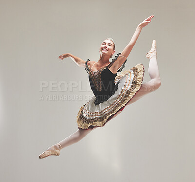Buy stock photo Elegant ballet dancer dancing with a vintage style, jumping and performing in a studio. Portrait of a skilled, talented and young ballerina leaping high in the air enjoying her performance