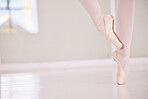 Ballet feet or legs on the tiptoe dancing or practicing in a dance studio or class with copy space. Closeup of an elegant dancer or ballerina in pointe shoes preparing for a performance