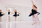 Ballerinas dancing or practicing in a dance studio or class ready for a performance. Elegant dancers training ballet moves by looking in a mirror and preparing for an entertainment gig