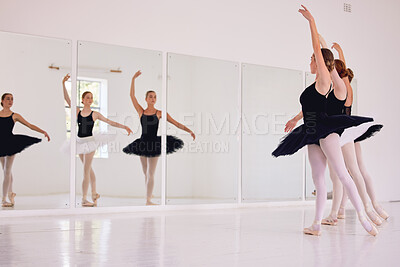 Buy stock photo Ballerinas dancing or practicing in a dance studio or class ready for a performance. Elegant dancers training ballet moves by looking in a mirror and preparing for an entertainment gig
