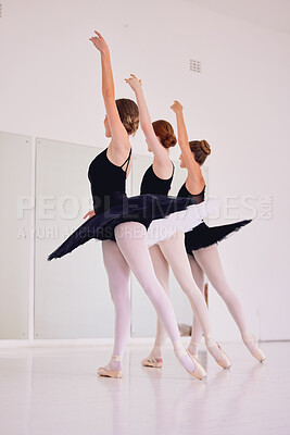 Buy stock photo Ballet dancers dancing and practicing in a dance studio together preparing for a performance. Group of elegant, skilled and talented ballerinas moving in sync and learning in a class or club