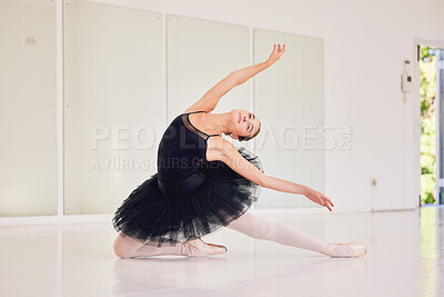 Buy stock photo Student ballerina dancer dancing, girl practicing a dance routine and getting ready for a performance at a studio alone. Elegant woman doing ballet poses and moves, rehearsing and looking graceful