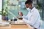 Hygiene, compliance and covid19 rules at work with an online operator sanitize hands before a shift. Call center worker cleaning workstation before going online with customer support and service
