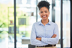 Success, leadership and professional businesswoman smiling while in a modern corporate office. Portrait of a confident worker, manager and young female leader standing with crossed arms at a company.