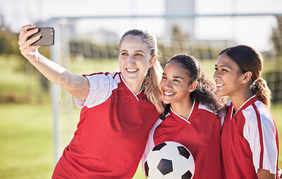 Buy stock photo Selfie, soccer and sports team smiling and feeling happy while posing for a social media picture. Diverse and young girls standing together on a football field. Friends and teammates enjoying a match