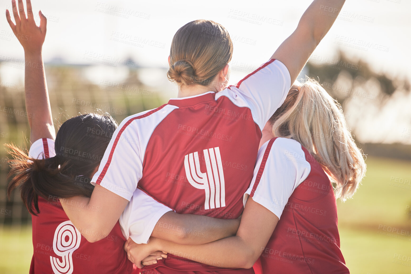 Buy stock photo Female football team celebrating winning, goal or teamwork effort at a game, tournament or during practice on a field outdoors. Behind of women with arms raised in celebration, victory and joy