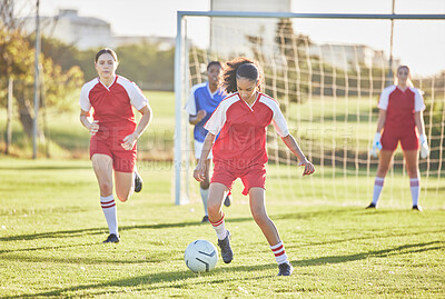 Buy stock photo Female football, sports and girls team playing match on field while kicking, tackling and running with a ball. Energy, fast and skilled soccer players in a competitive game against opponents outdoors