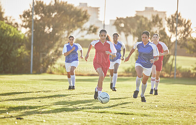 Buy stock photo Female football, sports and team playing match on a field while passing, touching and running with a ball. Active, fast and skilled soccer players in a competitive game on a pitch outdoors.