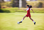 Football, soccer and running girl with a ball doing a sport exercise, workout and training. Moving and young woman student in a sports team uniform run a fitness cardio on a school grass field