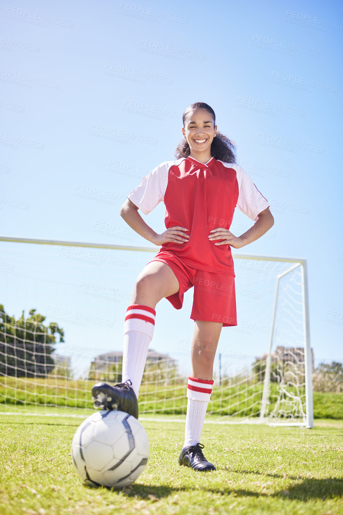 Buy stock photo Sports, football and female athlete training at stadium grass sport field with goal post. Portrait of smiling, excited and happy woman soccer player getting ready for workout standing on green pitch