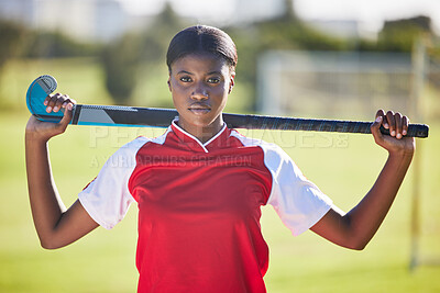 Buy stock photo Hockey player or coach holding stick ready for a competition or match on the sports ground or field. Portrait of a serious, fit and active black woman athlete at fitness training, exercise or workout
