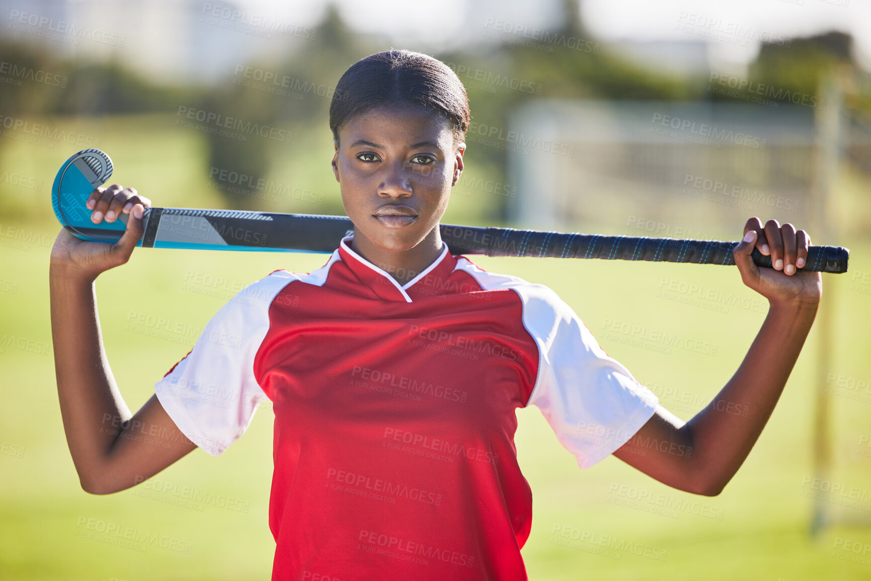 Buy stock photo Hockey player or coach holding stick ready for a competition or match on the sports ground or field. Portrait of a serious, fit and active black woman athlete at fitness training, exercise or workout