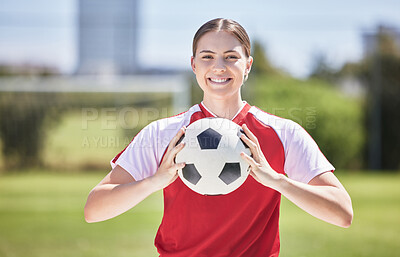 Buy stock photo Soccer player, ball and young woman happy to play a fun sports game in a practice stadium field in summer. Exercise, training and workout of a healthy, fitness and athlete smiling on a grass pitch