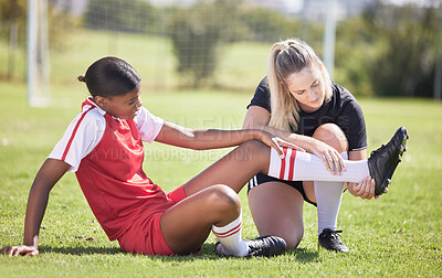 Buy stock photo Soccer, sports and injury of a female player suffering with sore leg, foot or ankle on the field. Painful, hurt and discomfort woman getting her pain checked out by athletic trainer on the pitch.