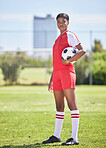 Soccer or football female player with ball for practice and training on sports field or stadium. Portrait of confident and competitive woman in sport kit ready for tournament game or match to start
