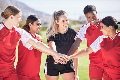 Buy stock photo Female only soccer team joining hands in a huddle in unity, support and trust before a match or competition. Happy group or squad of women's football players on a field standing in a circle