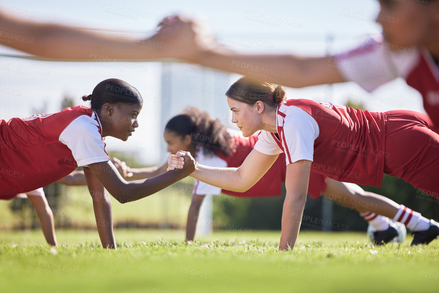 Buy stock photo Women soccer, football or team sports holding hands in unity, support or motivation in routine workout, exercise or training drill. Diverse group of fit, active or healthy athletes and girls on field
