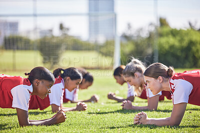 Buy stock photo Football, soccer and plank exercise drill of girls training team working on a fitness workout. Focus, motivation and teamwork collaboration of sports group of students on a school sport grass field