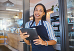Startup, cafe and business woman in management with smile working on a digital tablet at the store. Manager, coffee shop or worker of a small business at work in retail with technology.