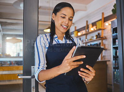 Buy stock photo Startup, entrepreneur and female cafe owner working on a digital tablet to plan a budget. Proud, positive and successful leader checking inventory. Small business owner with door open to customers