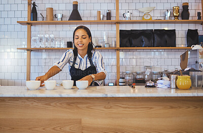 Buy stock photo Coffee shop, employee or worker of a woman in a retail business handing warm beverages on a counter at a cafe. Barista serving ready drinks on a table from orders for waiter or waitress to serve.
